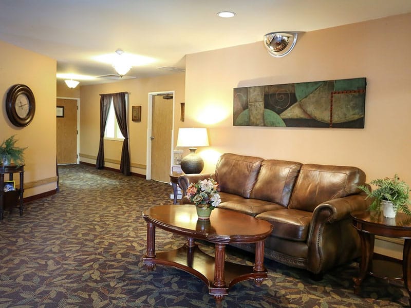 View leaving the waiting area with brown leather couch