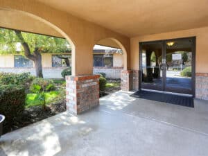 Covered front entrance to Bakersfield post acute with a breezeway and anti-skid map at the door.
